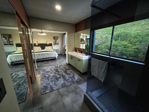 a large room with a bedroom and a bathroom at Villa Silver Vos in Hermanus