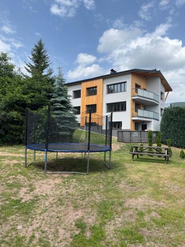 a playground in front of a building at Pension Salma in Cerny Dul