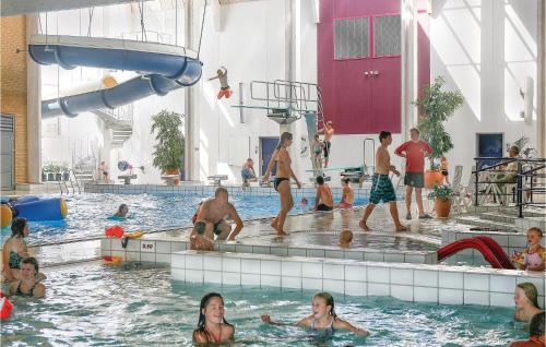 a group of people in the water at a swimming pool at Skærbæk Fritidscenter in Skærbæk