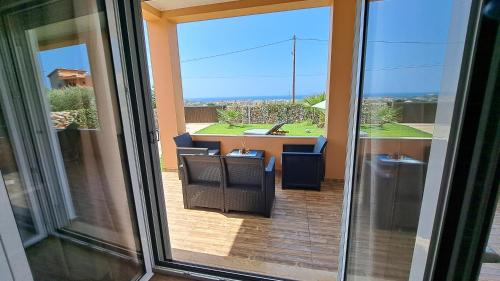a view of a balcony with a table and chairs at Villa Christina in Malia