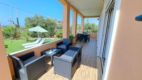 a balcony with chairs and a table and a patio at Villa Christina in Malia