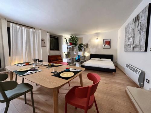 a living room with a table and chairs and a bed at Maremma Toscana Apartment in Manciano