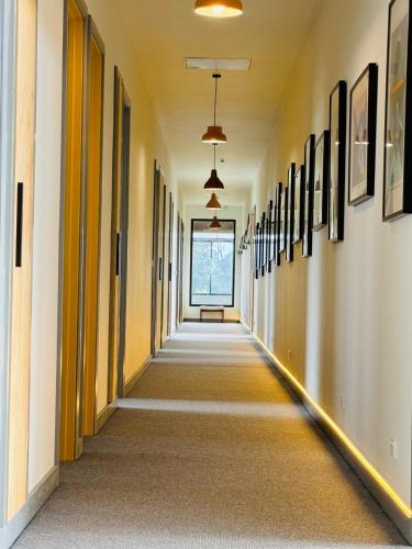 an empty hallway in a building with paintings on the walls at Farmstay in Central Victoria in Ballan