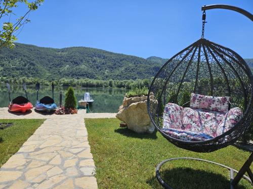 a swing in a yard with a view of a lake at Delta Lake House 1 in Velika Reka
