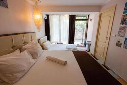 a bedroom with a large white bed with a large window at iVAVev IS US ByTheSea EforieSud in Eforie Sud