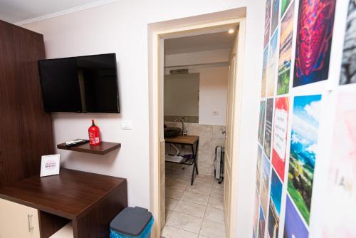 a room with a hallway with a television on a wall at iVAVev IS US ByTheSea EforieSud in Eforie Sud