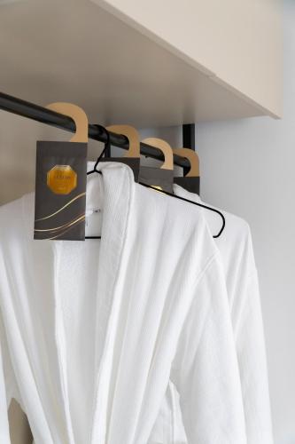 a towel rack with a white curtain on it at Mateo Apartments in Sarandë