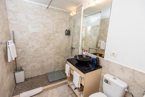 a bathroom with a toilet and a sink and a shower at iVAVev IS US ByTheSea EforieSud in Eforie Sud