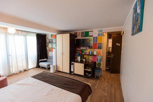 a bedroom with a bed and a chair in a room at iVAVev IS US ByTheSea EforieSud in Eforie Sud