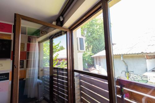 a sliding glass door in a room with a window at iVAVev IS US ByTheSea EforieSud in Eforie Sud
