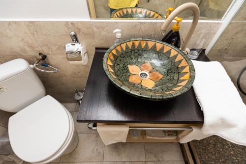 a bathroom with a toilet and a bowl on a table at iVAVev IS US ByTheSea EforieSud in Eforie Sud