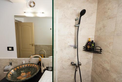 a shower in a bathroom with a sink and a mirror at iVAVev IS US ByTheSea EforieSud in Eforie Sud