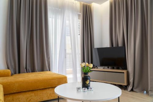a living room with a vase of flowers on a table at Mateo Apartments in Sarandë