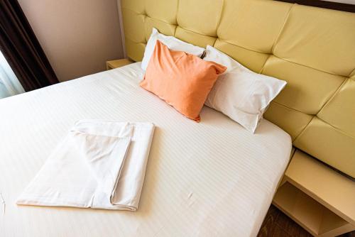 a bed with two pillows on top of it at iVAVev IS US ByTheSea EforieSud in Eforie Sud
