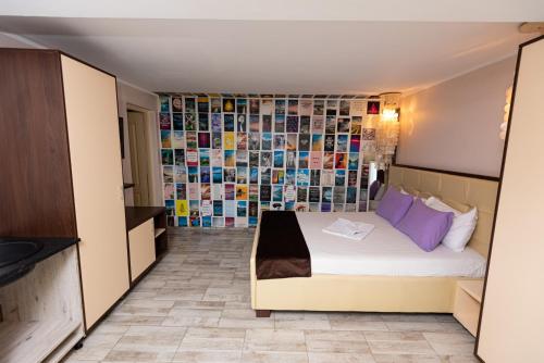 a bedroom with a bed and a wall of tiles at iVAVev IS US ByTheSea EforieSud in Eforie Sud