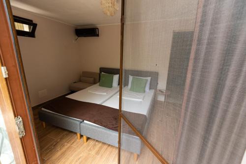 a small room with a bed and a glass wall at iVAVev IS US ByTheSea EforieSud in Eforie Sud