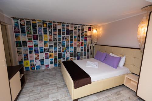 a bedroom with a bed with a wall of pictures at iVAVev IS US ByTheSea EforieSud in Eforie Sud