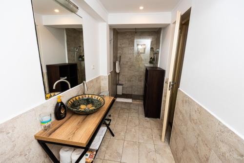 a bathroom with a wooden table and a shower at iVAVev IS US ByTheSea EforieSud in Eforie Sud