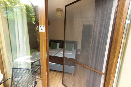 a glass door leading to a patio with a sink at iVAVev IS US ByTheSea EforieSud in Eforie Sud