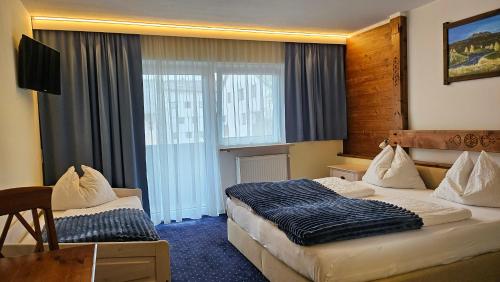 Postel nebo postele na pokoji v ubytování Panoramahotel