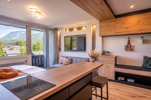 a kitchen with a counter and a large window at Suite Apartment modern getaway - Neu renoviert - Strobl am Wolfgangsee in Strobl