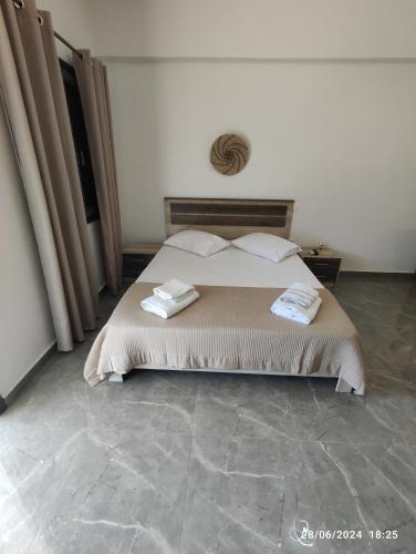 a bedroom with a bed with two towels on it at The View House 2 in Kithnos