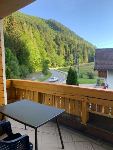 a table on a balcony with a view of a road at Ferienwohnung Marianne in Annaberg im Lammertal