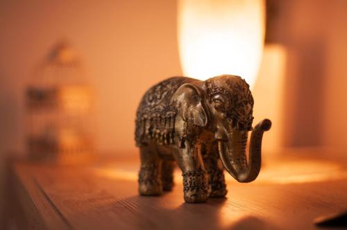 a small figurine of an elephant sitting on a table at Apartman Orhideja in Daruvar