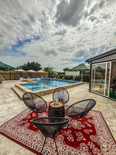 a patio with a table and chairs and a pool at Комплекс Радост in Ezerets