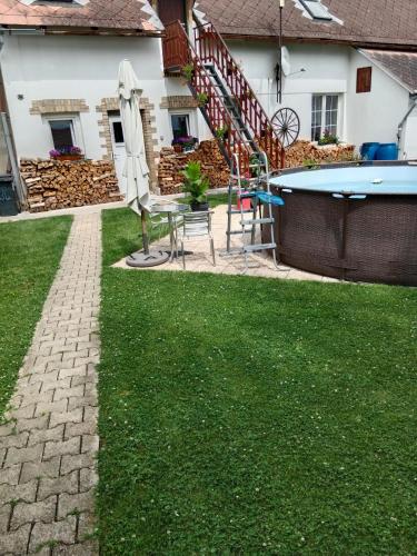 a backyard with a table and a pool at Chalupa u dědy in Dlažkovice
