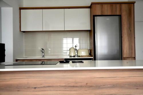a kitchen with white cabinets and a white counter top at Urban Oasis Retreat in Midrand