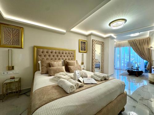 a bedroom with a large bed with towels on it at Mare Suites 4 in Chania