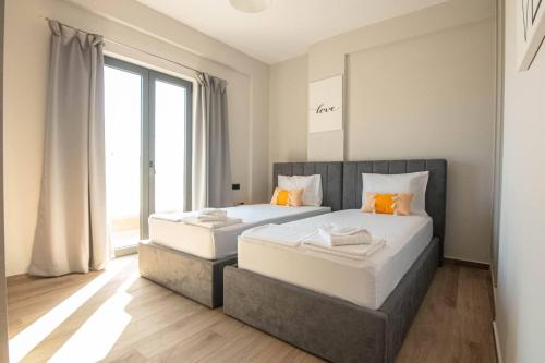 two twin beds in a room with a window at Filitsa's Luxury House in Chania Town