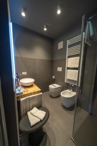 a bathroom with a sink and a toilet at Bach Boutique Hotel in Sappada