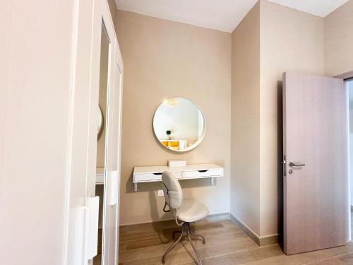 a bathroom with a mirror and a desk and a chair at 3BR Modern Getaway in Yas Island with Gym&Pool 609WE in Abu Dhabi