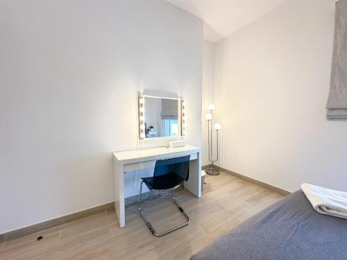 a white bedroom with a desk and a mirror at 3BR Modern Getaway in Yas Island with Gym&Pool 609WE in Abu Dhabi