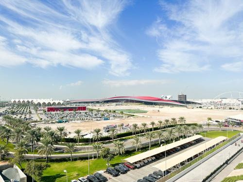 a parking lot with palm trees and a stadium at 3BR Modern Getaway in Yas Island with Gym&Pool 609WE in Abu Dhabi