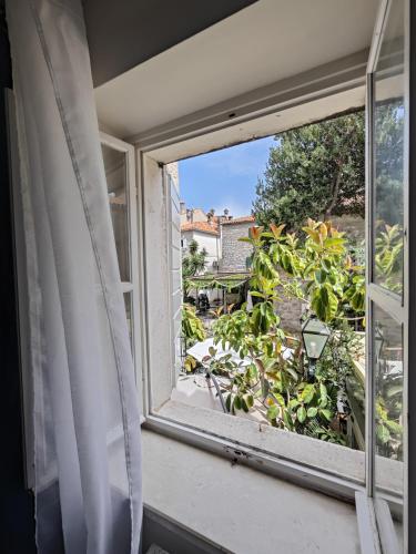 an open window with a view of a garden at Beatrix Suites in Budva