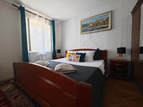 a bedroom with a bed and a window at Beatrix Suites in Budva