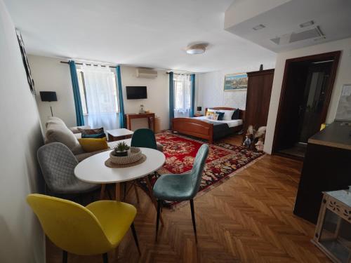 a living room with a table and chairs at Beatrix Suites in Budva