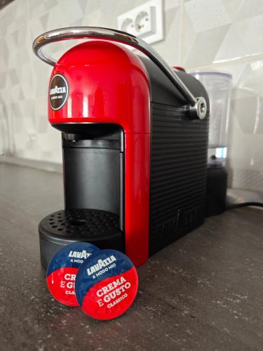 a red toaster sitting on top of a counter with two stickers at Beatrix Suites in Budva