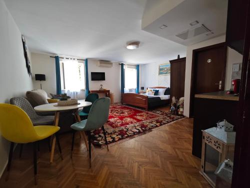 a living room with a table and chairs at Beatrix Suites in Budva