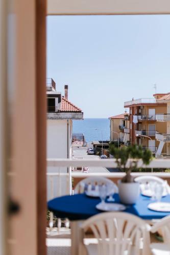 a blue table with chairs and a view of the ocean at Casa Ferrari Vista Mare in Formia