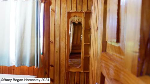 a wooden hallway with a mirror in a room at Baey Bōgan Homestay in Sagada