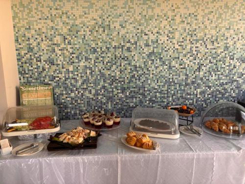 a table with different types of pastries on it at Thesmos Village in Mýtikas
