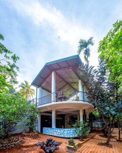 a large house with a balcony on top of it at JayS Place Matale in Kavudupelella