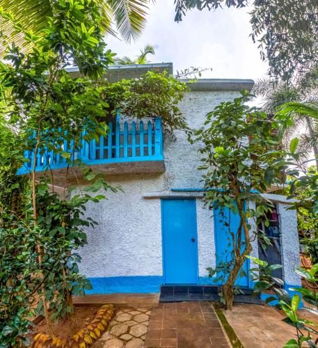 a blue door on a house with trees at JayS Place Matale in Kavudupelella