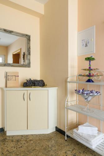 a room with a white cabinet and a mirror at Apartments Jozic in Trogir