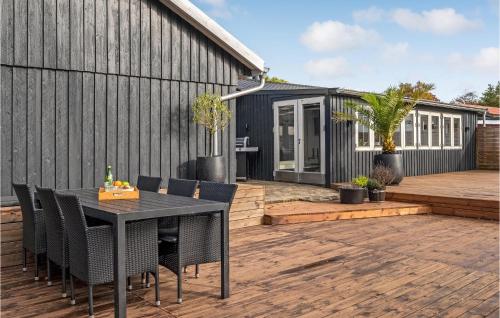 a patio with a table and chairs and a building at Stunning Home In Holbæk in Holbæk