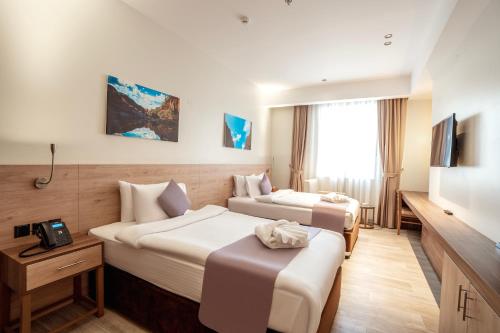 Postel nebo postele na pokoji v ubytování Kyriad Muscat